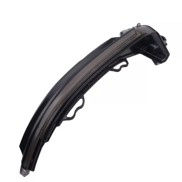 A sleek, black curved car headlight component with mounting brackets is positioned diagonally on a plain white background.