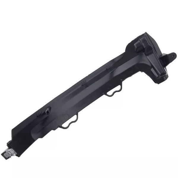 A black, angular plastic car component with multiple ridges and mounting points, possibly a bumper bracket, rests against a plain, white background.