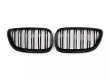Two black kidney-shaped car grilles with vertical slats, positioned side by side against a plain white background.