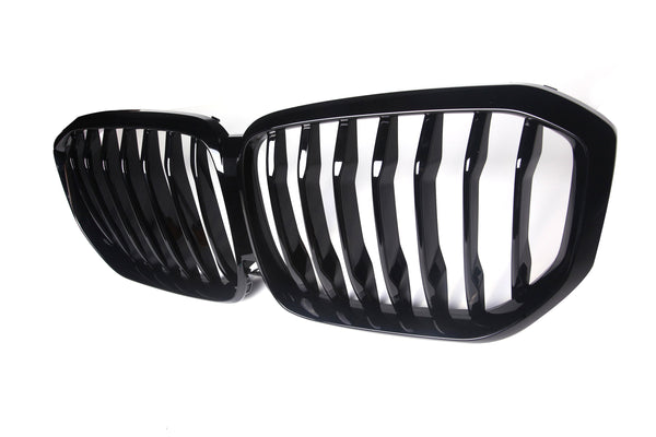 A black grille with vertical slats is positioned side-by-side, designed for a vehicle's front. It is set against a plain white background, emphasizing its shiny finish.