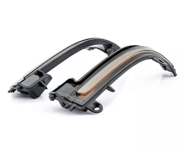 Two black, curved LED turn signal lights for a vehicle, resting side-by-side on a plain white background, with a sleek design and translucent covering.