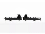 Black, rectangular plastic parts with hooks and protrusions lay side-by-side on a white background, appearing to be components of a larger assembly piece.