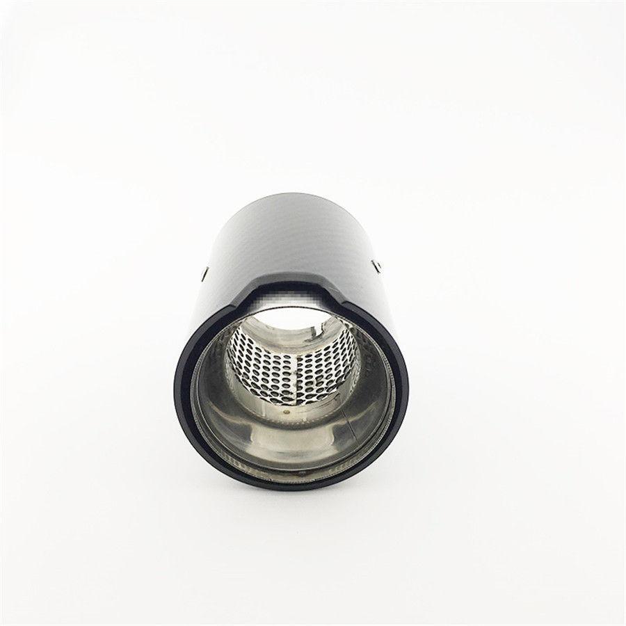 A cylindrical black metal exhaust tip with a perforated inner pipe rests upright against a plain white background.