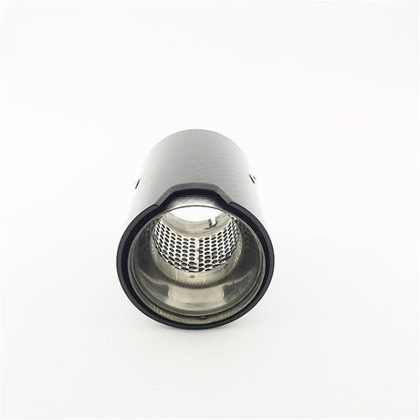 A black cylindrical exhaust tip, featuring a metallic interior with perforated detailing, is positioned upright in a minimalist, white background setting.