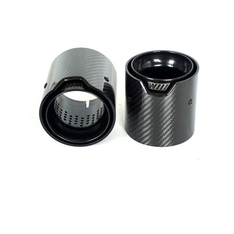 Two carbon fiber cylindrical exhaust tips are positioned upright and slightly angled against a white background. Each has a visible perforated inner surface; one displays the text "WIII" on its edge.