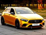 Yellow car parked, featuring black grille and wheels, with a 