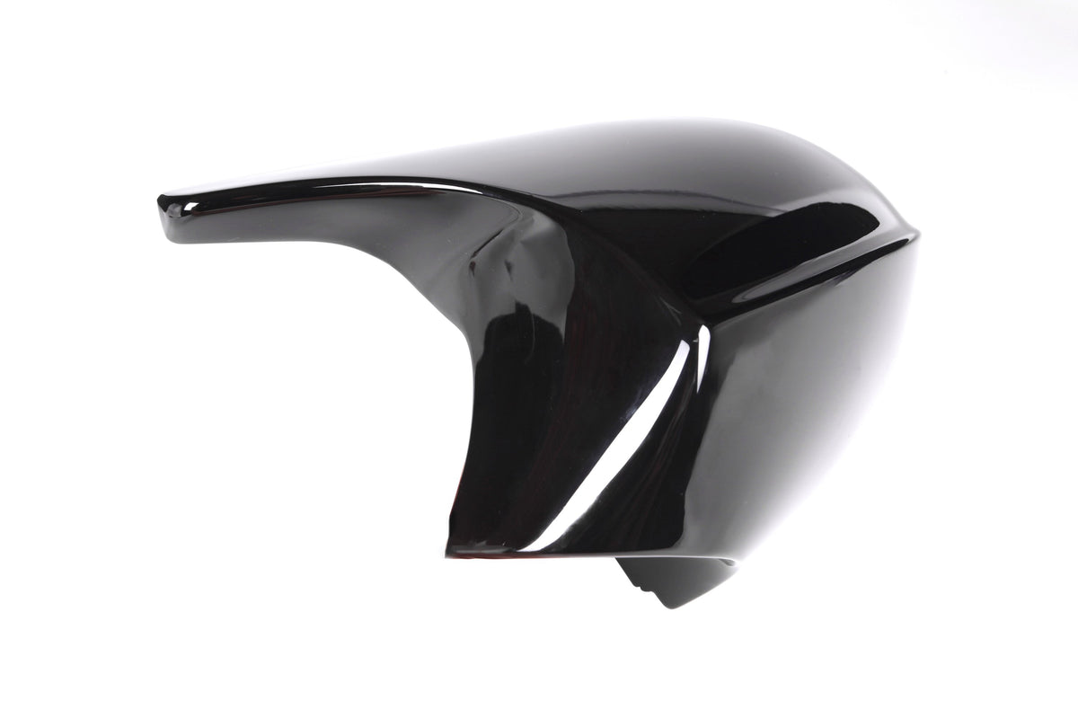 A glossy black motorcycle fairing sits on a white background, showcasing its smooth, aerodynamic curves and reflective surface.