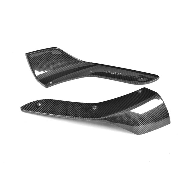 Two black carbon fiber automotive parts are placed on a white background. Text on one part reads "M&L-235-V1R7-2". Both parts have a sleek, aerodynamic design with mounting holes.