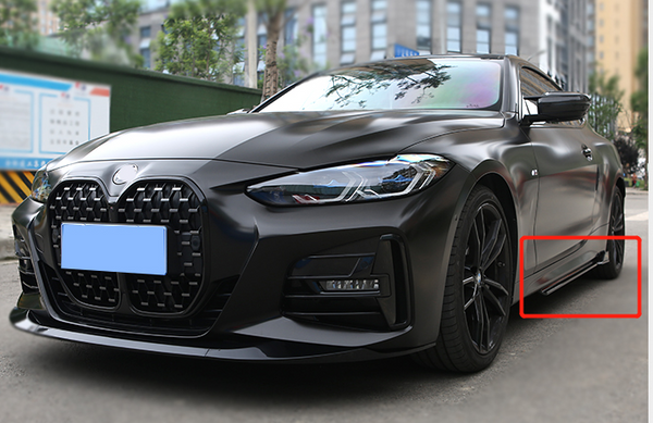 A sleek, black car is parked on a city street. Its shiny exterior and modern design, featuring an intricate front grille and sharp headlights, stand out against the urban setting.