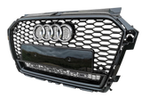 A black car grille with a honeycomb pattern, featuring four chrome rings and "quattro" text, is displayed against a plain background.