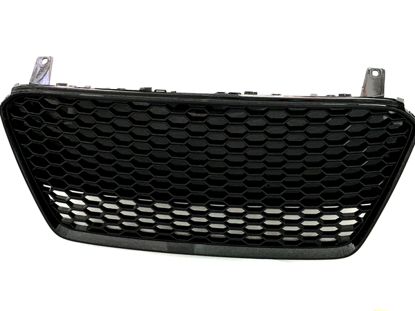 The object is a black, hexagonal-patterned car grille, resting upright against a plain white background, designed for ventilation and protection in automotive use.